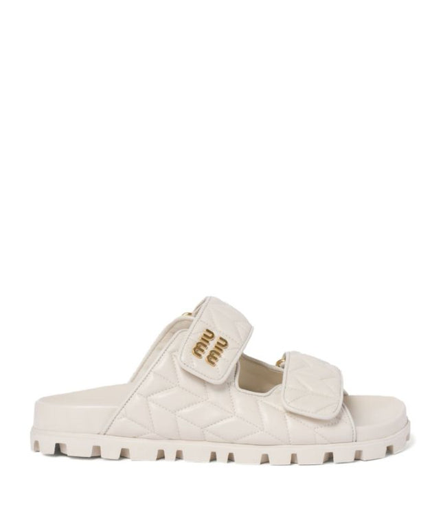 Miu Miu
Matelassé nappa leather slides