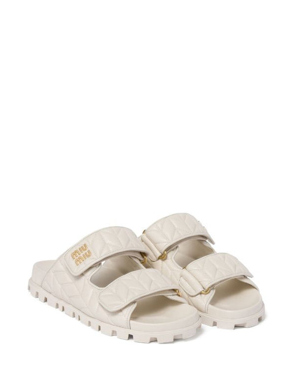 Miu Miu
Matelassé nappa leather slides